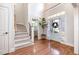 Spacious foyer with hardwood floors, staircase, and ample natural light at 7336 Capulin Crest Dr, Apex, NC 27539
