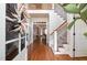 Elegant foyer featuring hardwood floors, staircase with iron railings, and a welcoming entryway at 7336 Capulin Crest Dr, Apex, NC 27539