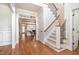 Inviting foyer with hardwood floors, staircase, and views into the living room at 7336 Capulin Crest Dr, Apex, NC 27539