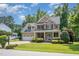 Handsome brick home featuring a two-car garage, covered entry, and lush green landscaping at 7336 Capulin Crest Dr, Apex, NC 27539
