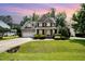 Charming brick home featuring a manicured lawn, two-car garage, and inviting front porch at 7336 Capulin Crest Dr, Apex, NC 27539