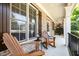Cozy covered front porch with rocking chairs and views of the surrounding landscape at 7336 Capulin Crest Dr, Apex, NC 27539