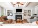 Comfortable living room with fireplace, custom built-ins, and bright, natural light at 7336 Capulin Crest Dr, Apex, NC 27539