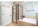 Luxurious main bathroom offers a glass shower, soaking tub, and modern finishes at 7336 Capulin Crest Dr, Apex, NC 27539