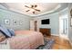 Spacious primary bedroom with ensuite bathroom, tray ceiling and hardwood floors at 7336 Capulin Crest Dr, Apex, NC 27539