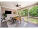 Relaxing screened porch with TV, ceiling fan, and outdoor dining, ideal for entertainment at 7336 Capulin Crest Dr, Apex, NC 27539