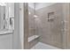 Modern bathroom features a glass shower, built-in seat, and neutral tile, offering a spa-like experience at 8415 Zinc Autumn Path, Raleigh, NC 27615