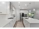 Modern white kitchen with stainless steel appliances, island seating, and ample counter space at 8415 Zinc Autumn Path, Raleigh, NC 27615