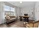 Comfortable home office with a large window, plush seating, and built-in shelving for storage or display at 8415 Zinc Autumn Path, Raleigh, NC 27615