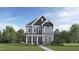 Two-story home with gray siding, stone foundation, covered front porch and well-manicured landscaping at 925 Crossbill Dr, Knightdale, NC 27545
