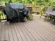 Upper level deck with covered barbecue grill and patio table at 10 Winchester Ct, Durham, NC 27707