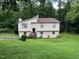 Two-story home with a well-manicured lawn, mature trees, and a charming front porch at 10 Winchester Ct, Durham, NC 27707