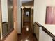 Hallway with warm lighting and wood flooring leads to a beautifully decorated home at 10 Winchester Ct, Durham, NC 27707
