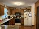 Functional kitchen with wood cabinets and appliances at 10 Winchester Ct, Durham, NC 27707