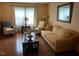 Cozy living room with hardwood floors, comfortable seating, and natural light from large window at 10 Winchester Ct, Durham, NC 27707