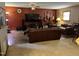 A cozy living room with warm tones, a ceiling fan and a large TV with musical instruments on display at 10 Winchester Ct, Durham, NC 27707