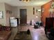 A living room featuring a brown leather couch, decorative masks, and a small white fridge at 10 Winchester Ct, Durham, NC 27707