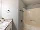 Bathroom featuring a shower-tub combo, granite vanity and updated fixtures at 102 Sanair Ct, Apex, NC 27502