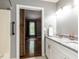 Bright bathroom featuring a double sink vanity and barn door access to the bedroom at 102 Sanair Ct, Apex, NC 27502