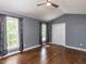 Bedroom filled with natural light from large windows and has hardwood flooring at 102 Sanair Ct, Apex, NC 27502