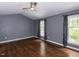 An empty bedroom with dark hardwood floors and light grey walls at 102 Sanair Ct, Apex, NC 27502