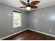 Bedroom with hardwood floors, ceiling fan, and a large window at 102 Sanair Ct, Apex, NC 27502