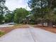 Home's exterior with a driveway and mature trees at 102 Sanair Ct, Apex, NC 27502