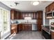 Modern kitchen with stainless steel appliances, dark wood cabinets, and granite countertops at 102 Sanair Ct, Apex, NC 27502