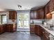 Kitchen with dark wood cabinets, granite countertops, subway tile backsplash and gray tile floors at 102 Sanair Ct, Apex, NC 27502