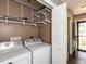 Efficient laundry room with washer, dryer, and shelving at 102 Sanair Ct, Apex, NC 27502