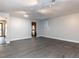 Empty living room featuring track lighting and gray floors at 102 Sanair Ct, Apex, NC 27502