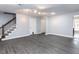 Empty Living room featuring grey floors, staircase, and white walls at 102 Sanair Ct, Apex, NC 27502