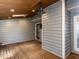 Screened porch features wood floors, ceiling fan, and door to outside at 102 Sanair Ct, Apex, NC 27502