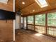 This sunroom features a wood paneled wall, a skylight, and many windows at 102 Sanair Ct, Apex, NC 27502