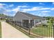 Fenced backyard with a well-maintained lawn, screened in porch, and patio area at 1021 Shellbank Dr, Durham, NC 27703