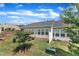 Private backyard featuring a lush lawn, mature trees, and a charming patio area at 1021 Shellbank Dr, Durham, NC 27703