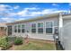 Well-kept backyard with a mix of green grass, mature shrubs, and a home air conditioning unit at 1021 Shellbank Dr, Durham, NC 27703