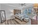 Bright bedroom with hardwood floors and a tray ceiling for added architectural detail at 1021 Shellbank Dr, Durham, NC 27703