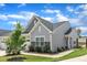 Beautifully landscaped home exterior with stone accents, lush green lawn, and charming architectural details at 1021 Shellbank Dr, Durham, NC 27703