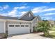Attached two-car garage, with a light gray color, and attractive stone accents on a well-maintained property at 1021 Shellbank Dr, Durham, NC 27703