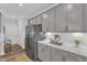 Stylish kitchen featuring modern gray cabinets, stainless steel refrigerator, and quartz countertops at 1021 Shellbank Dr, Durham, NC 27703