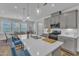 Bright kitchen with gray cabinetry, stainless steel appliances, and a large island adjacent to the dining area at 1021 Shellbank Dr, Durham, NC 27703