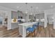 Modern kitchen with gray cabinets, stainless steel appliances, and a large island with seating at 1021 Shellbank Dr, Durham, NC 27703