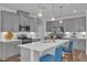 Stylish kitchen featuring gray cabinets, stainless steel appliances, and a spacious island at 1021 Shellbank Dr, Durham, NC 27703
