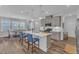 Open kitchen layout with gray cabinets, stainless steel appliances, and an island with barstool seating at 1021 Shellbank Dr, Durham, NC 27703