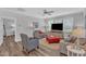 Bright living room with hardwood flooring, stylish furniture, and abundant natural light from the window at 1021 Shellbank Dr, Durham, NC 27703