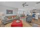 Inviting living room with gray sofa, red ottoman, open floor plan, and abundant natural light at 1021 Shellbank Dr, Durham, NC 27703