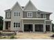 Two story home with a three car garage and large windows at 1025 Azalea Garden Cir, Raleigh, NC 27603