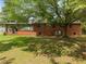 Backyard view of brick home with covered patio, perfect for outdoor entertaining and relaxation at 1051 Old Us 421, Lillington, NC 27546
