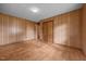 Bedroom with panel walls, wood floors, closet, and access to another room at 1051 Old Us 421, Lillington, NC 27546